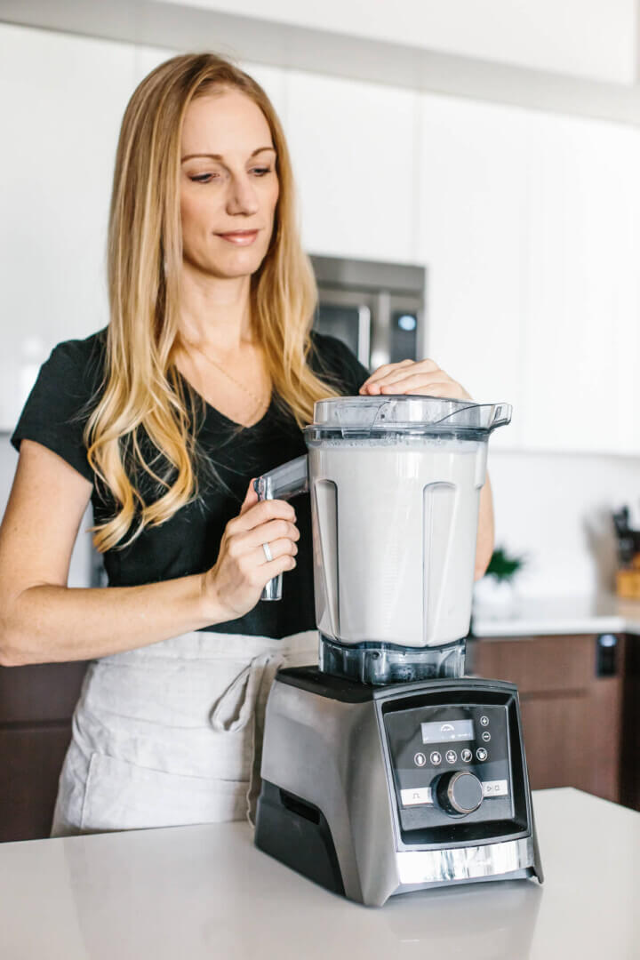 Making almond milk in kitchen in a blender