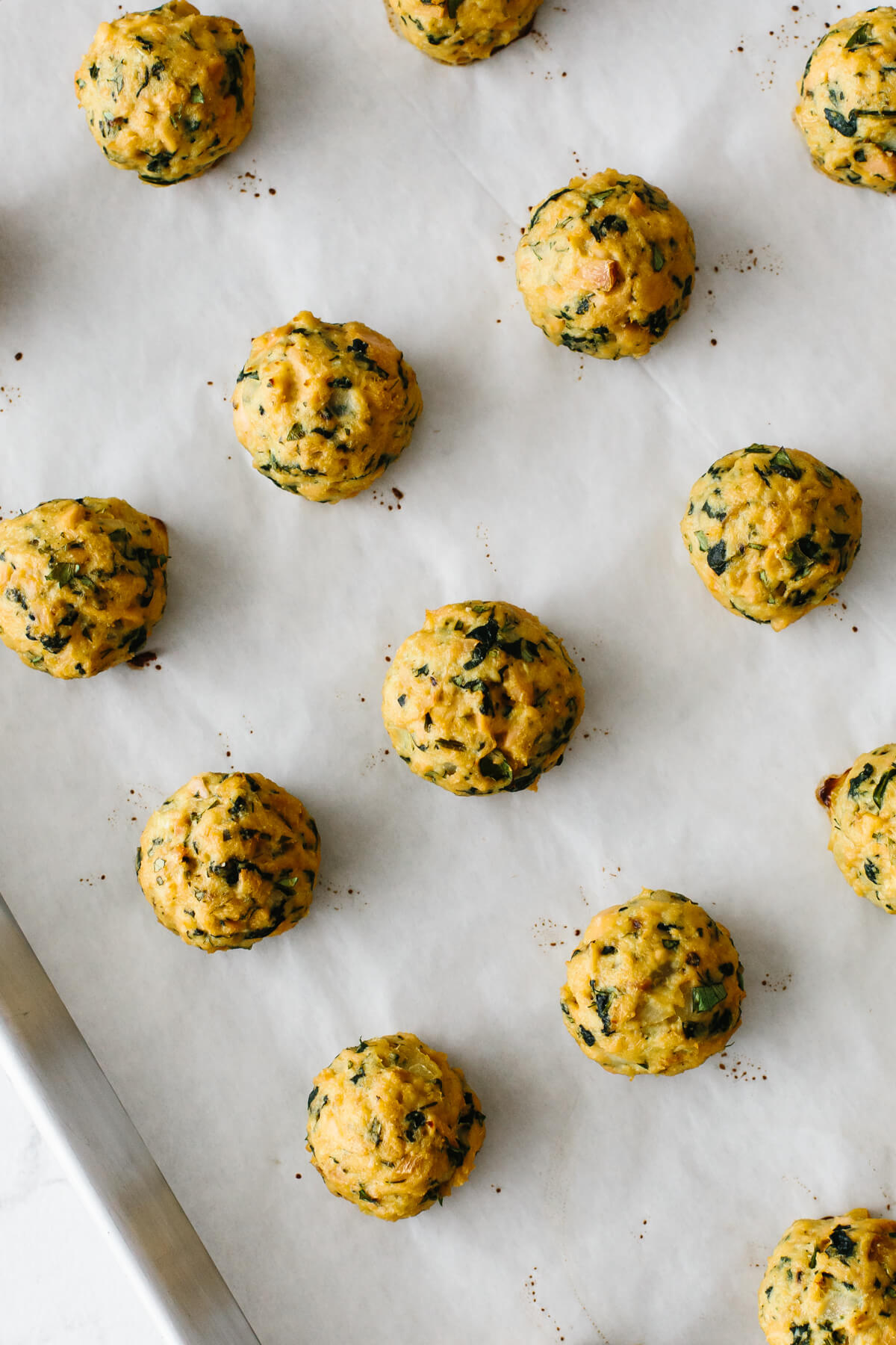 Tuna meatballs that have been cooked on a baking tray.
