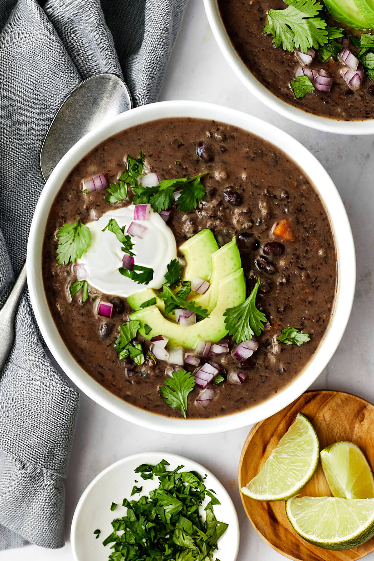 Black bean soup in a bowl next to a napkin