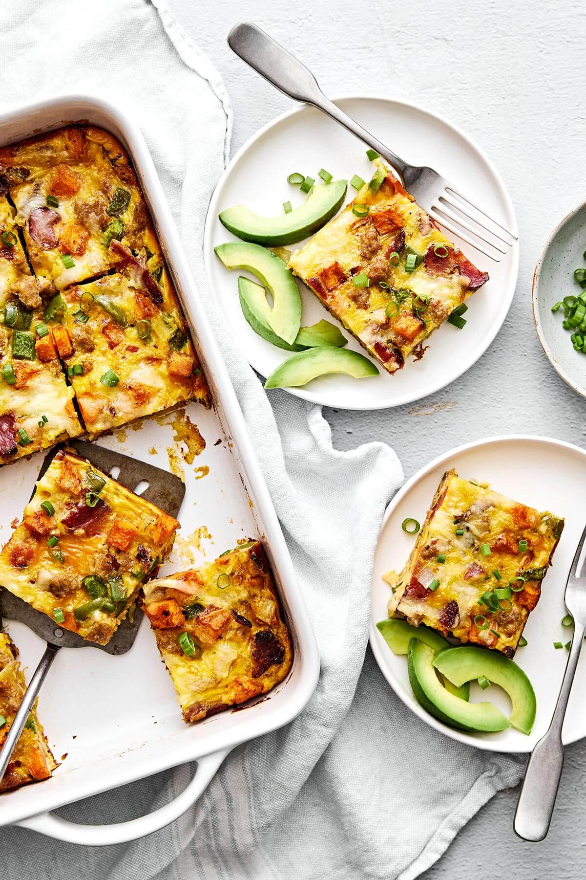 Slices of breakfast casserole on plates.