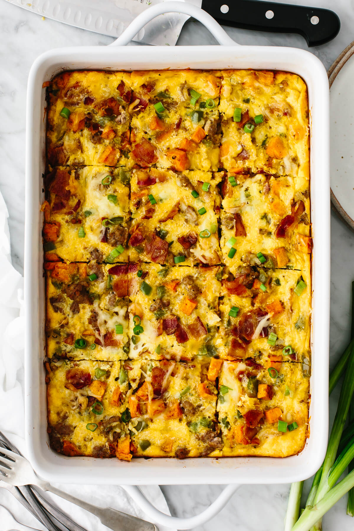Loaded breakfast casserole in a pan on a table.