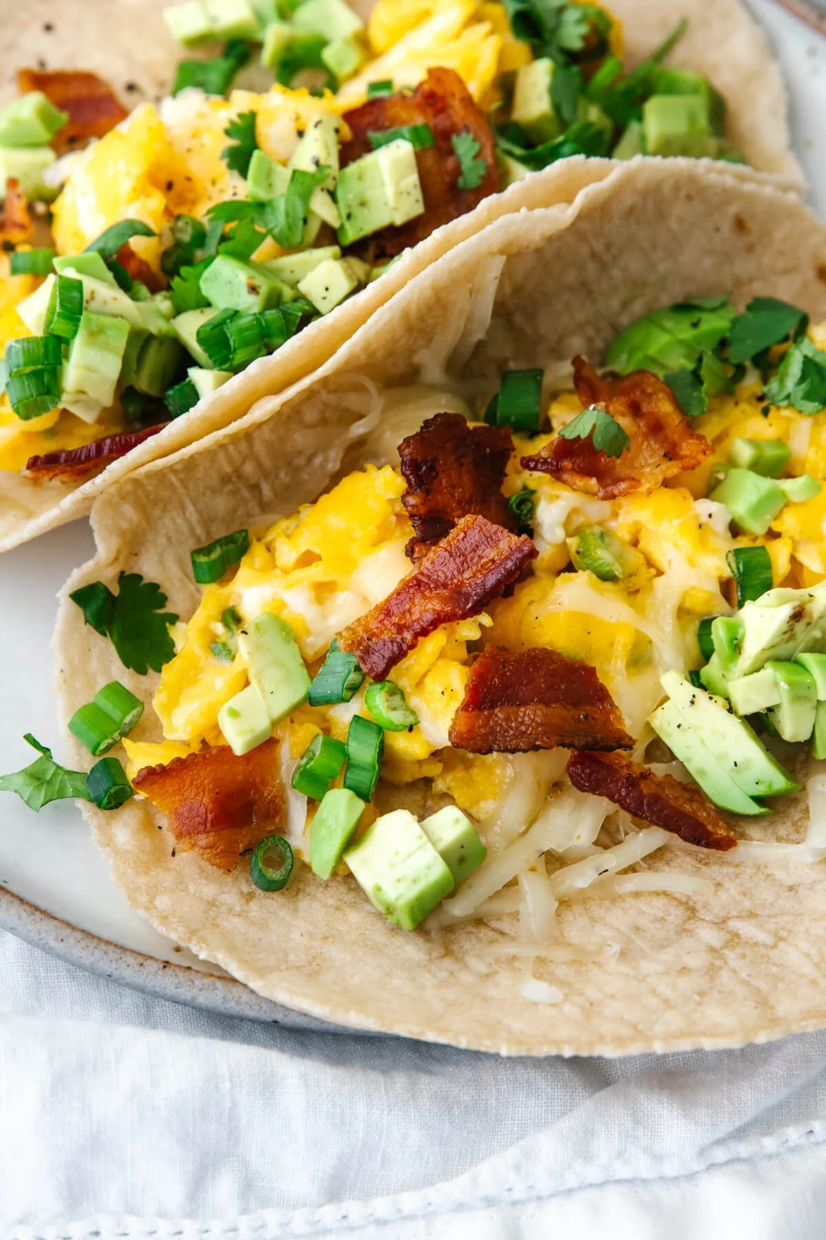 Breakfast tacos on a plate with a napkin.