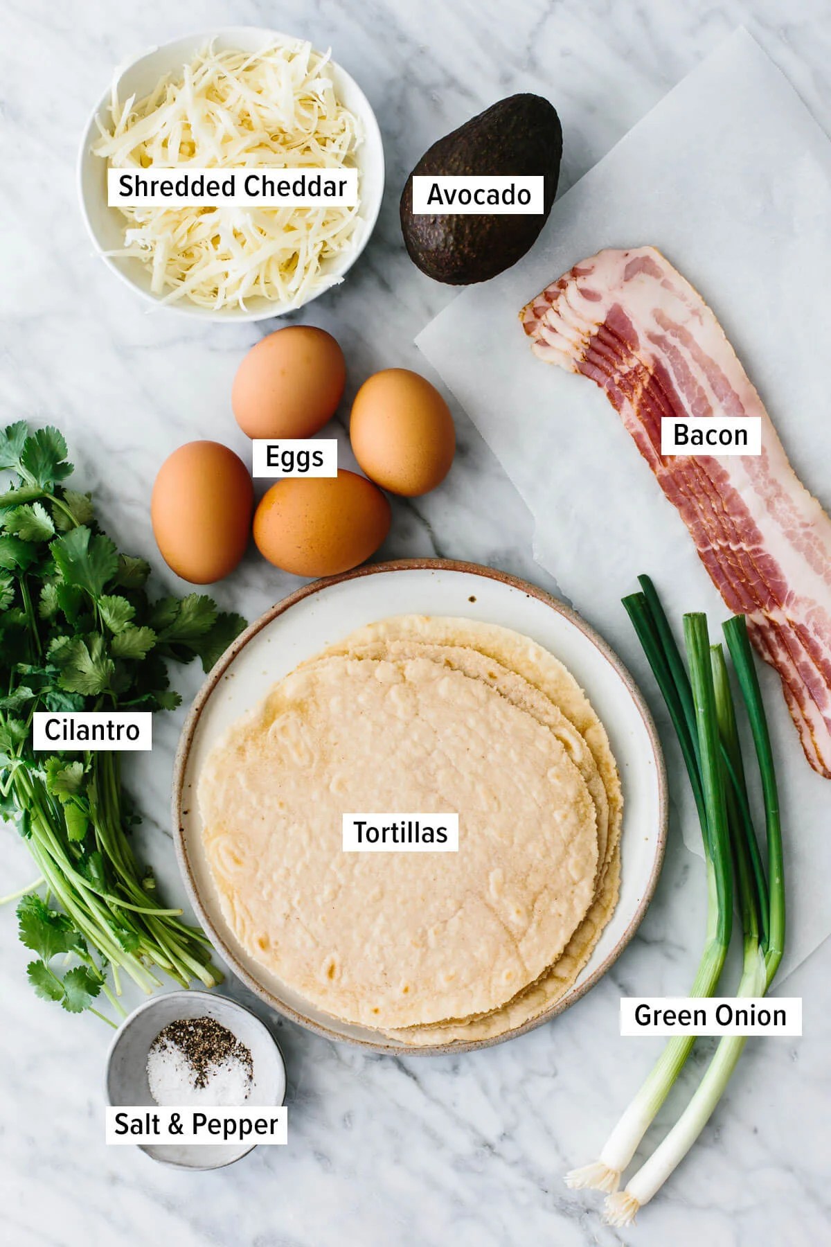 Ingredients for breakfast tacos on a table.