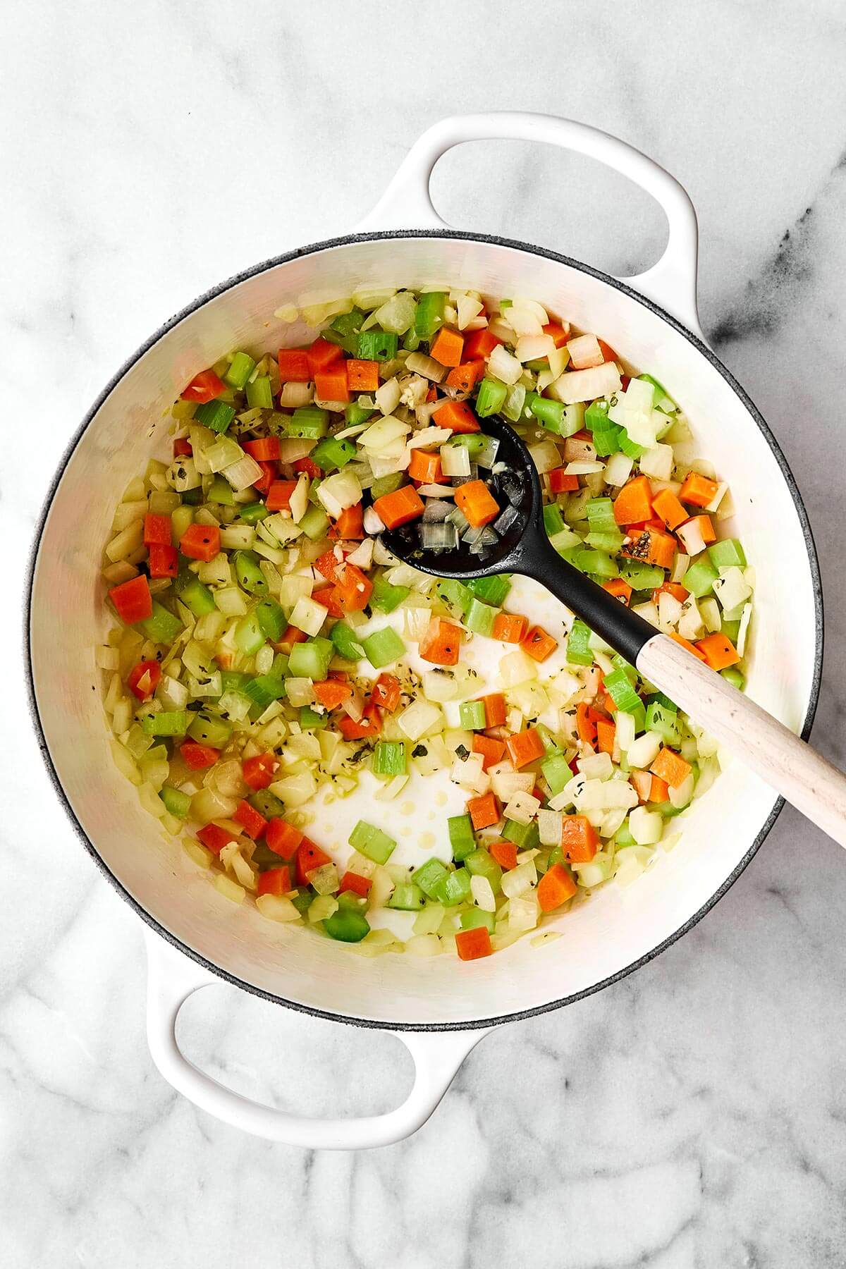 Cooked mirepoix vegetables in a pot.