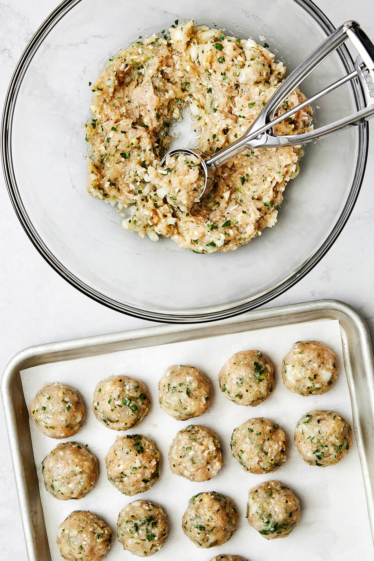 Rolling chicken meatballs together