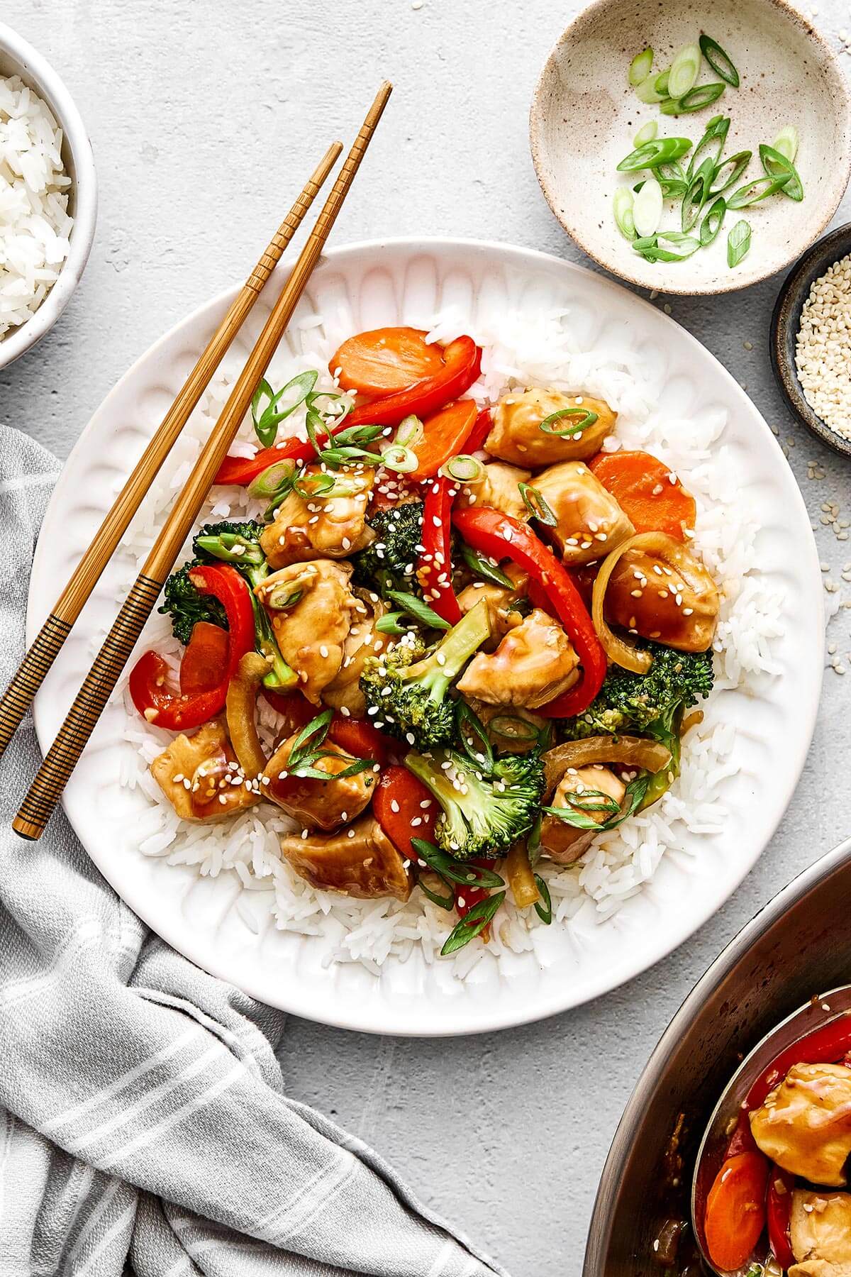 Chicken stir-fry and rice on a plate.