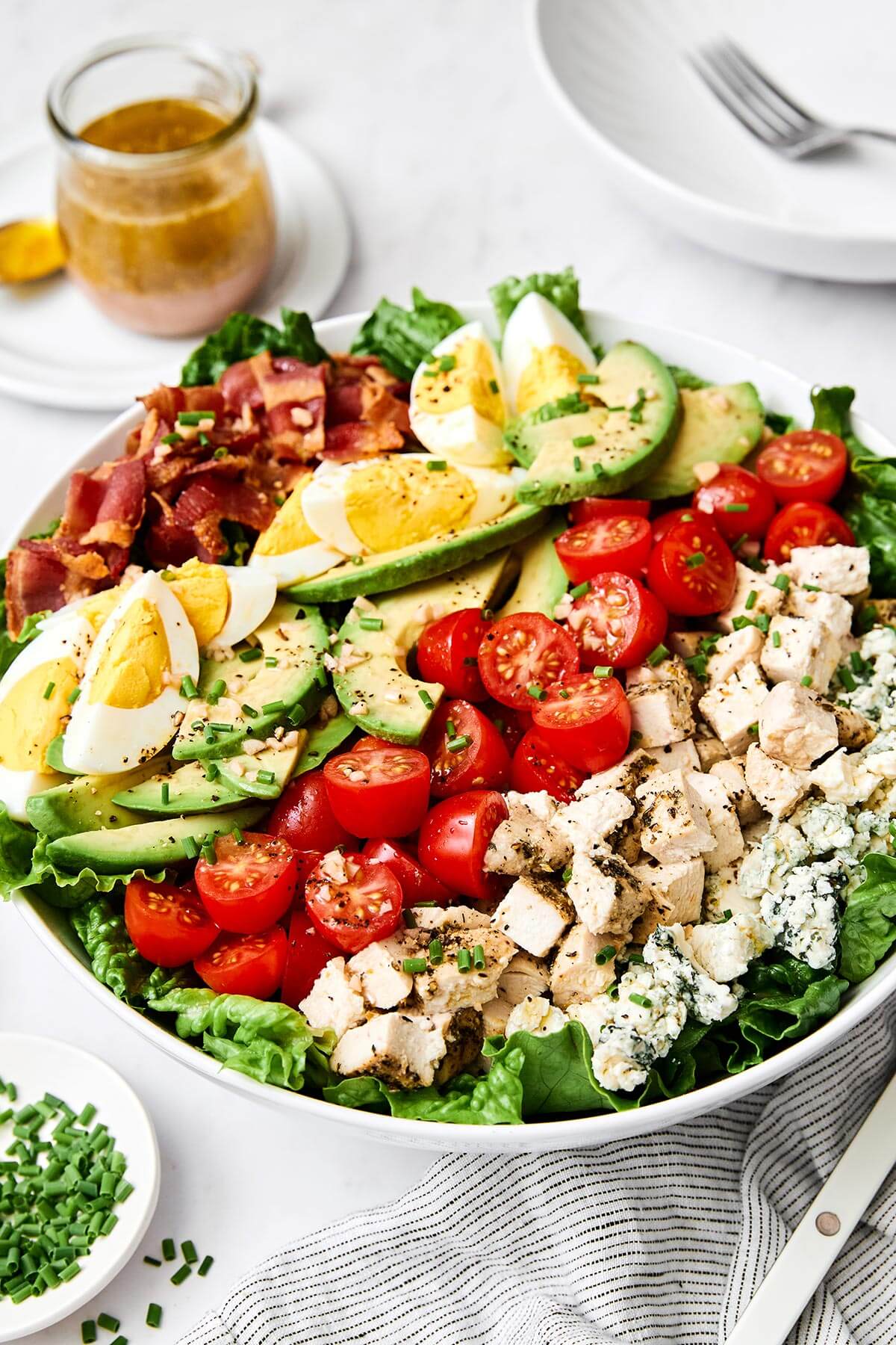 A white bowl of Cobb salad.
