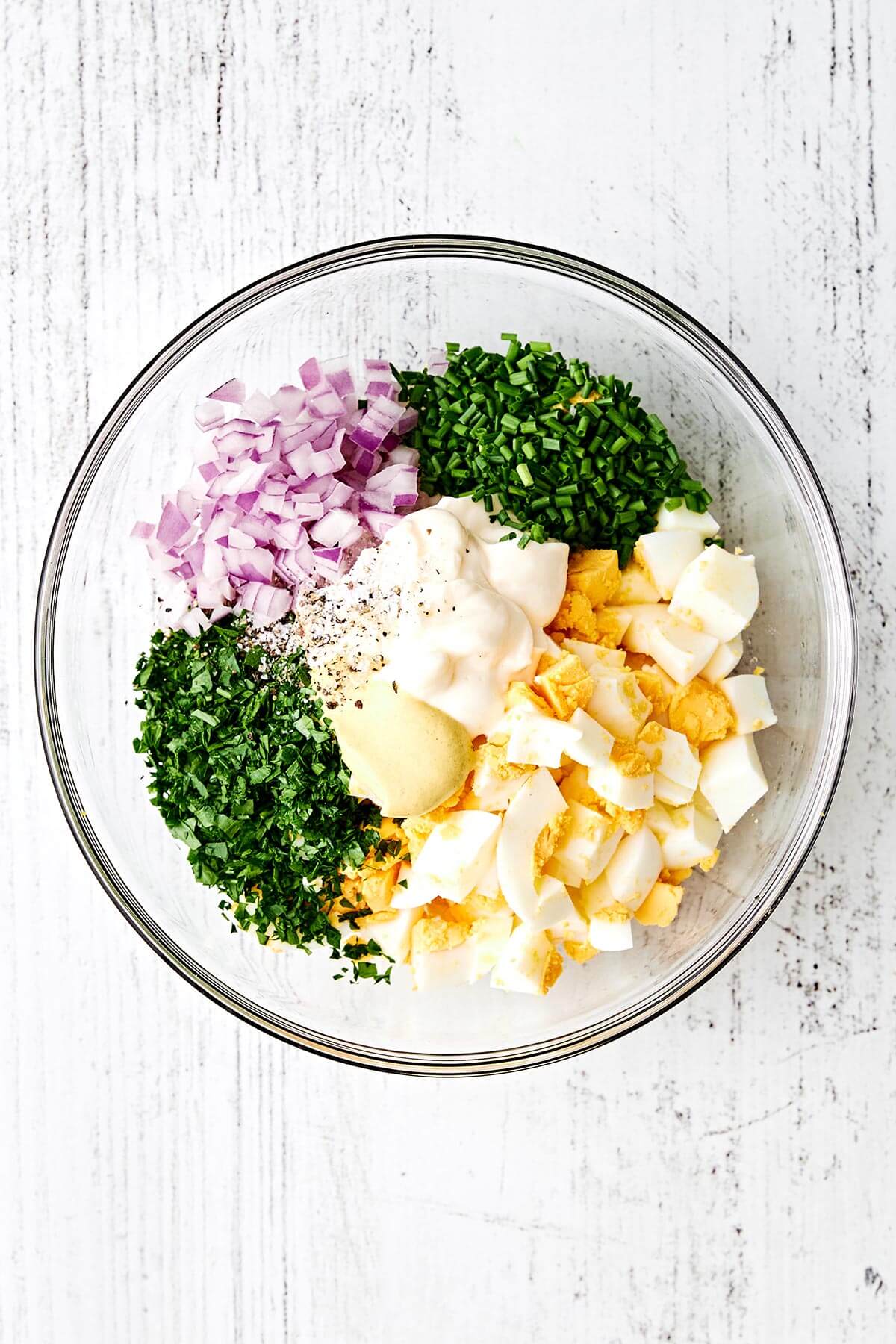 Egg salad ingredients in a bowl.