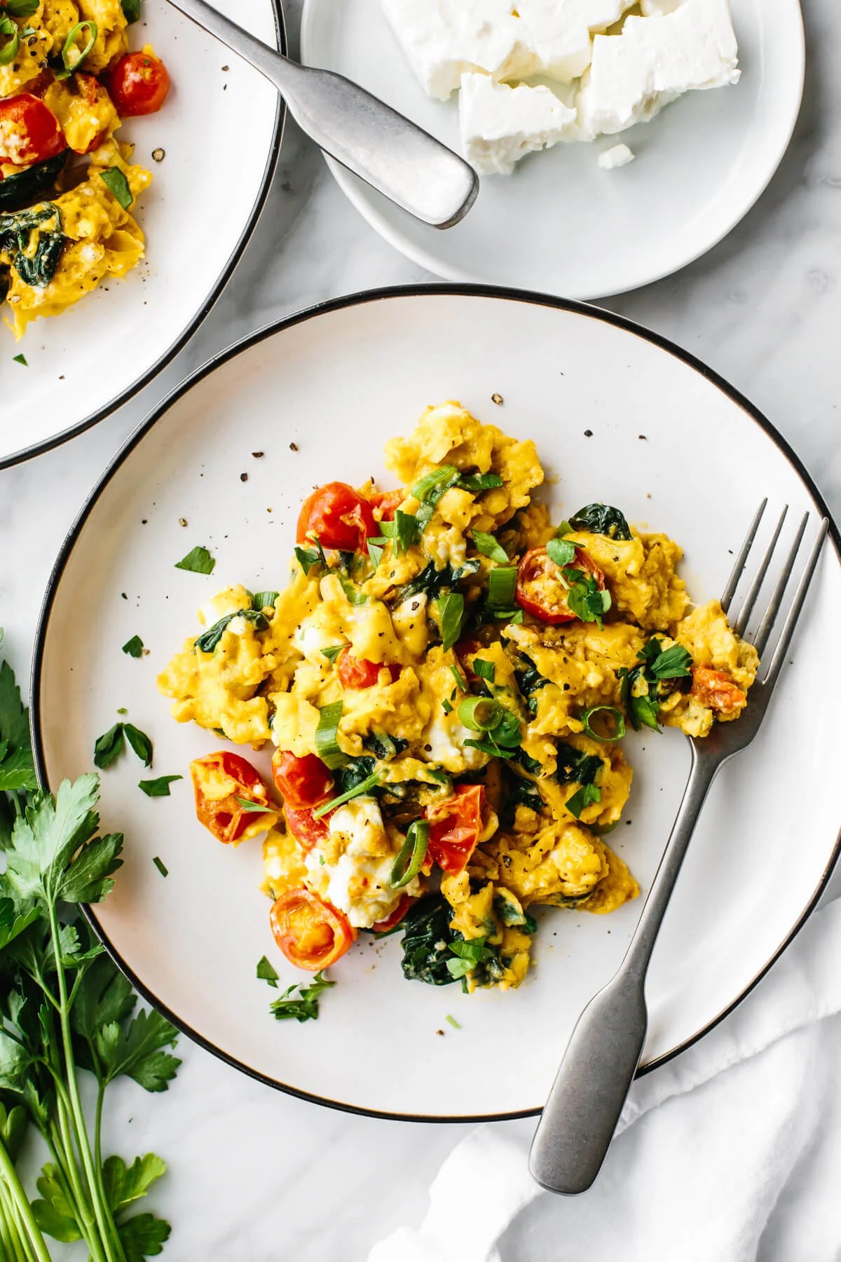 Greek scrambled eggs on a white plate