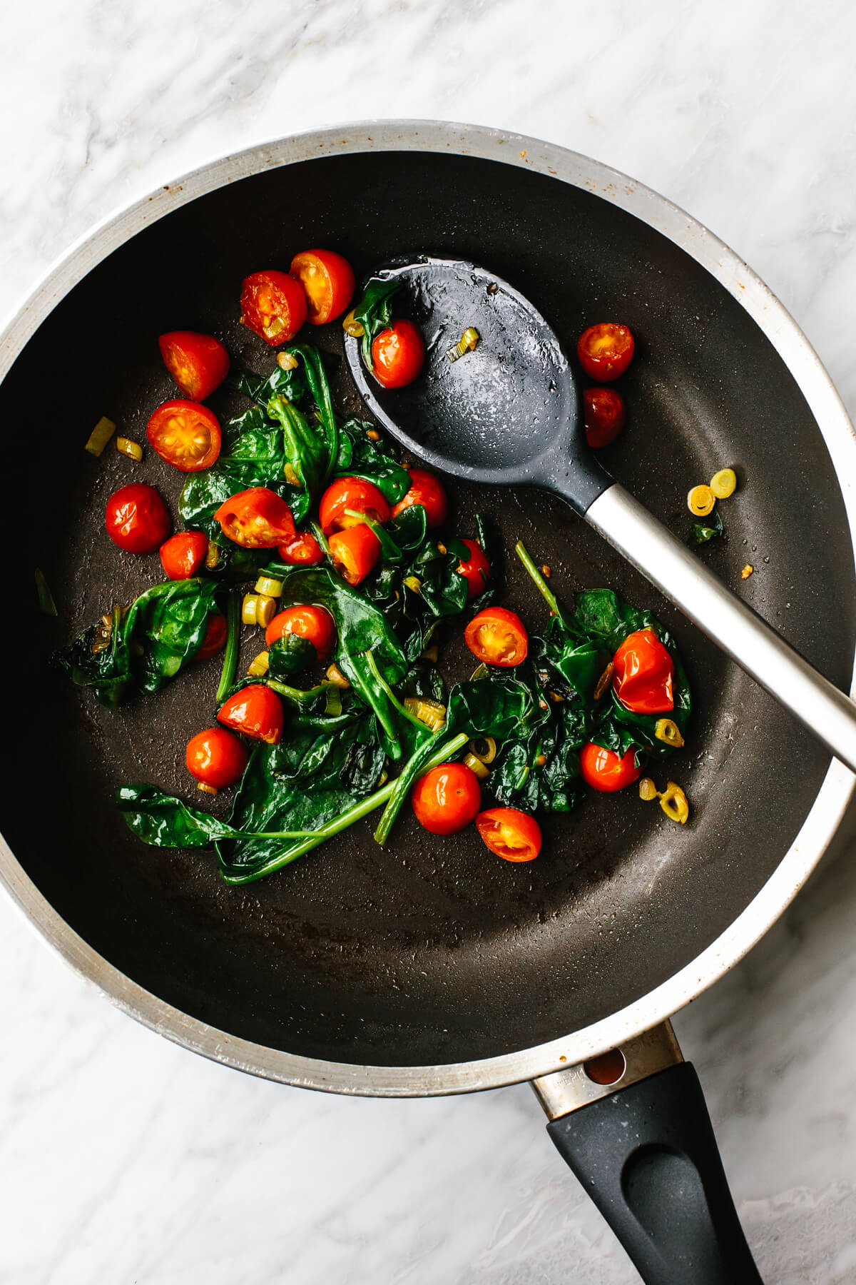 Cooking veggies in a pan for Greek scrambled eggs