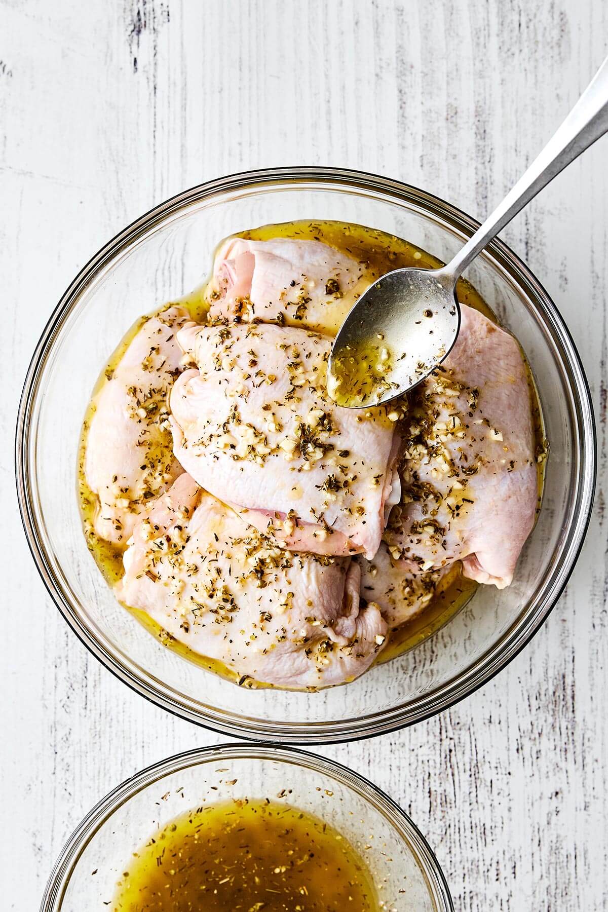 Marinating chicken thighs in a bowl.