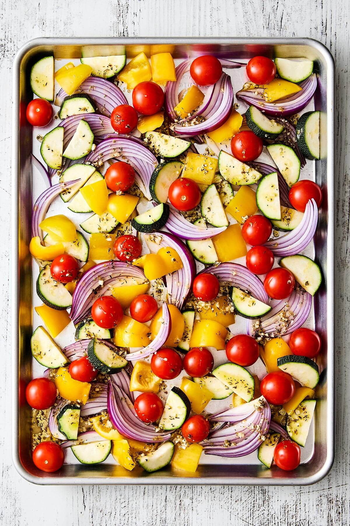 Seasoned vegetables on a sheet pan.