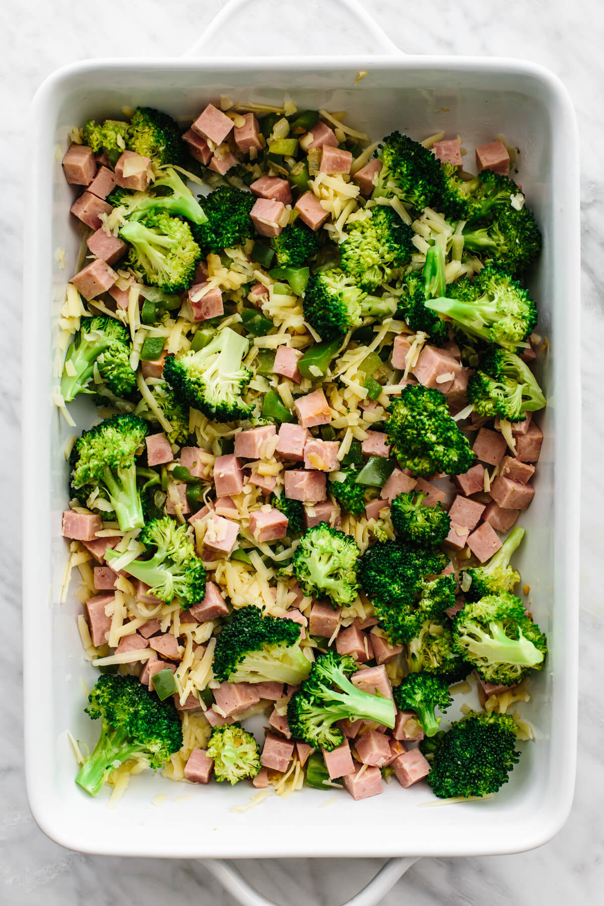 Adding ham and broccoli casserole ingredients into baking dish