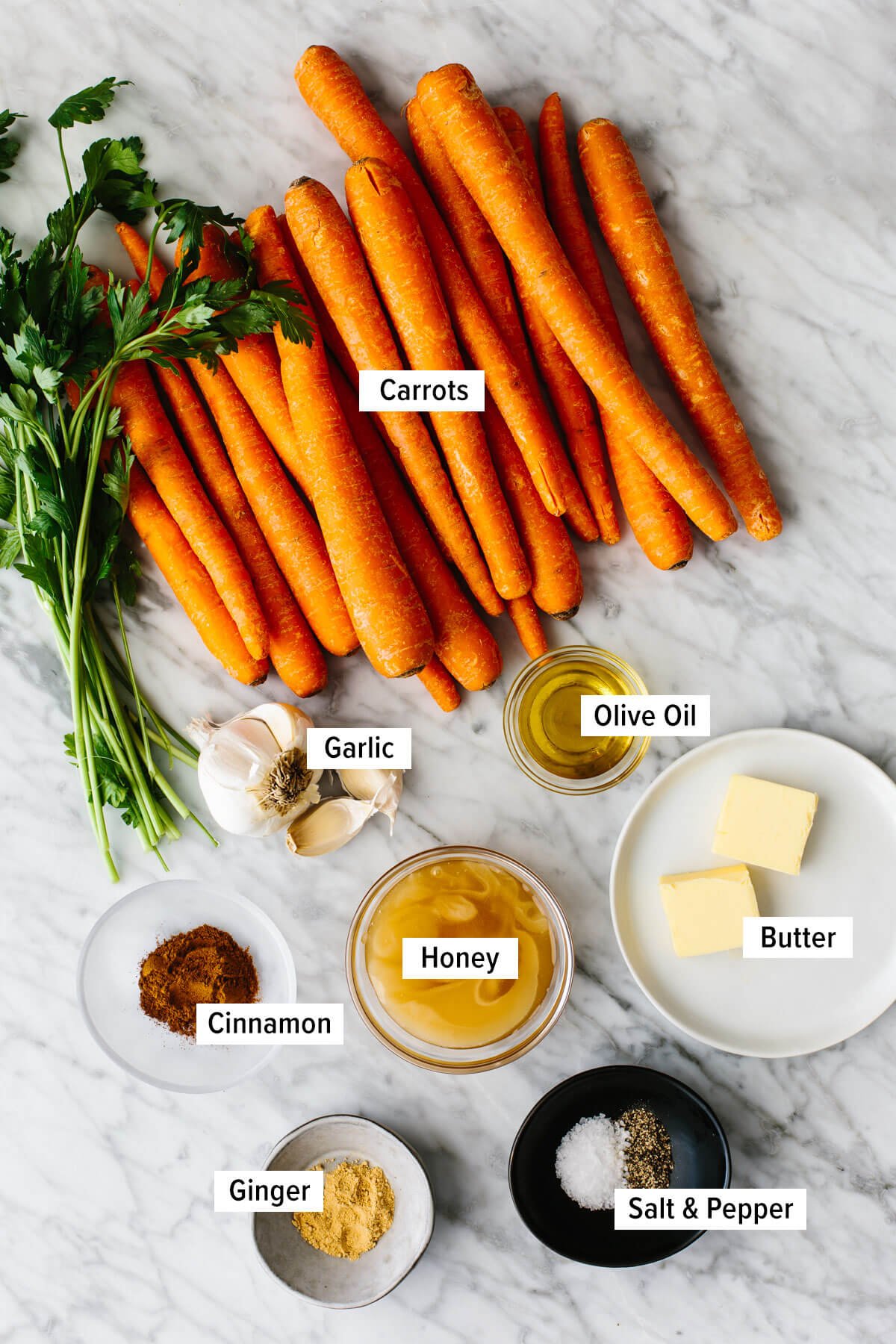 Ingredients for honey glazed carrots on a table.