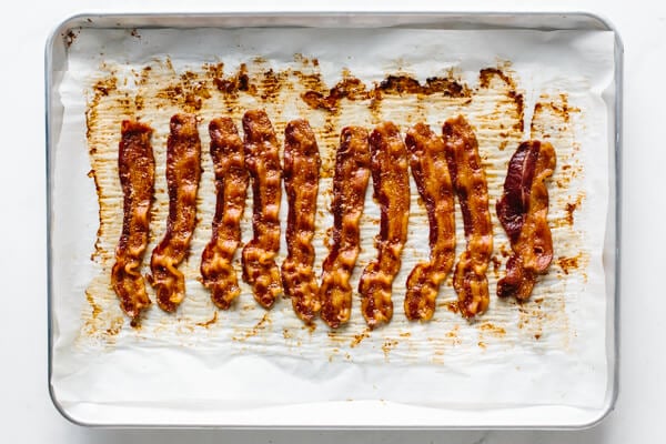 Cooked bacon on a baking tray.