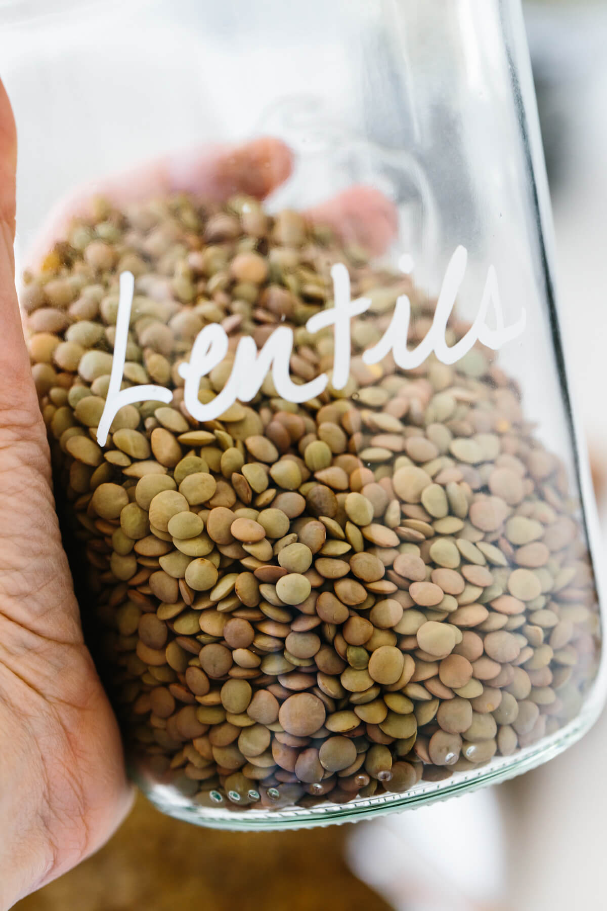 A glass jar full of dried lentils.