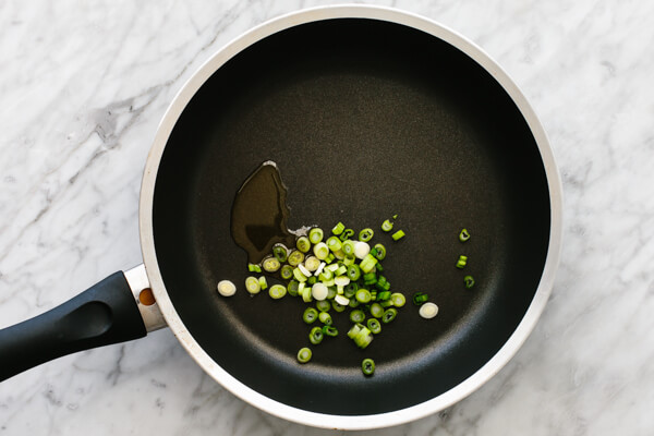 Sauteeing green onions for breakfast tacos.