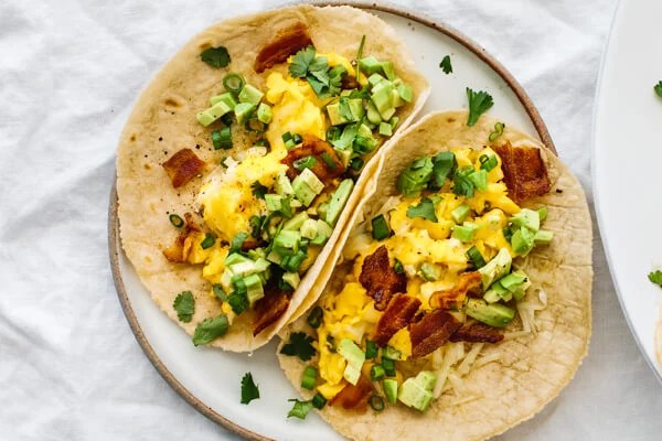 A plate with two breakfast tacos.