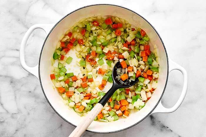 Cooked vegetables in a white pot.
