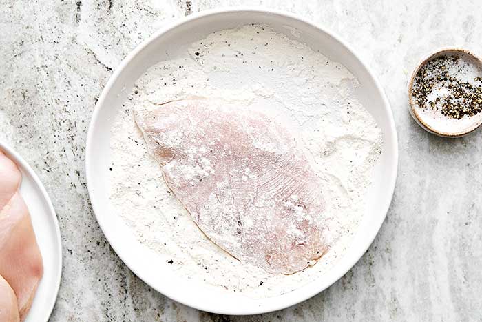 Chicken breasts in flour.