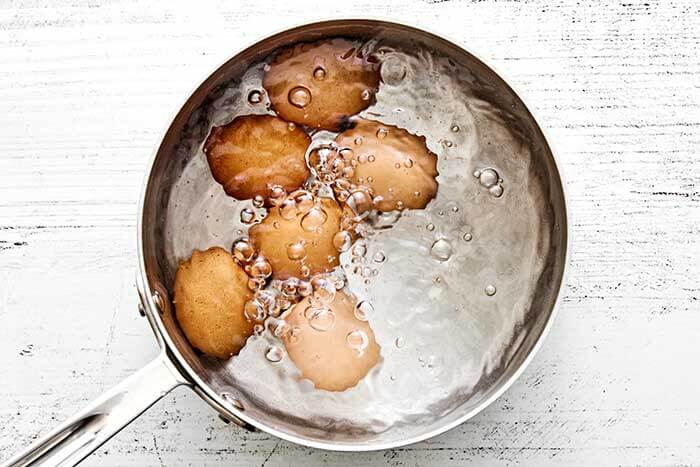 Eggs boiling in a pot.