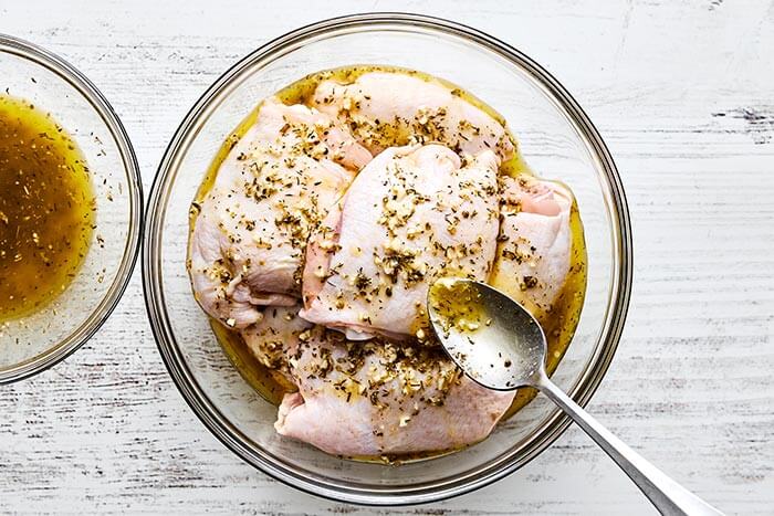 Marinated Greek lemon chicken in a bowl.