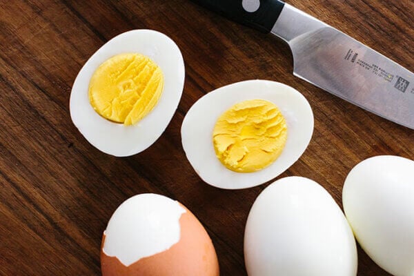 Sliced hard boiled eggs on a chopping board