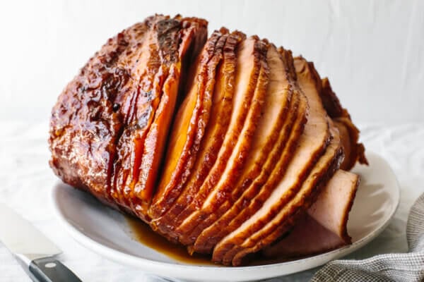 A large honey baked ham on a plate