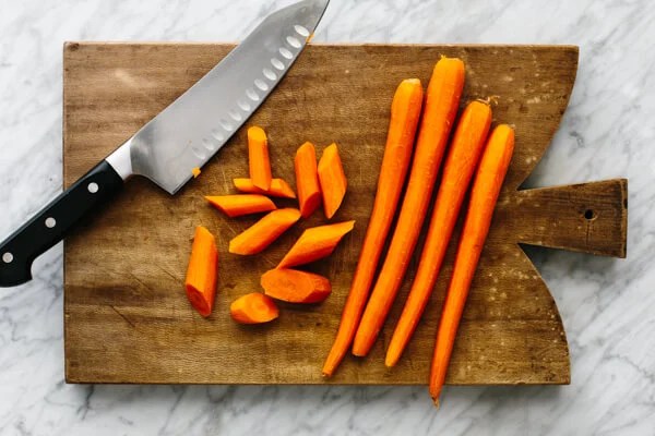 Carrots being chopped for honey glazed carrots.