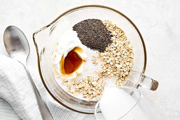 Mixing overnight oats in a large bowl.