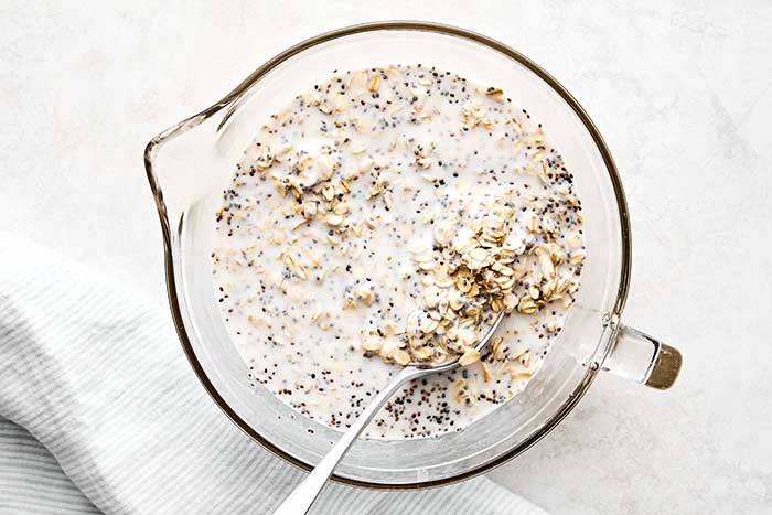 Mixed overnight oats in a glass bowl.