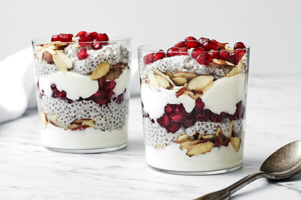 2 clear glasses of pomegranate chia pudding parfaits