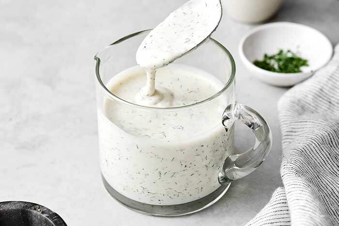 Ranch dressing in a glass jar.