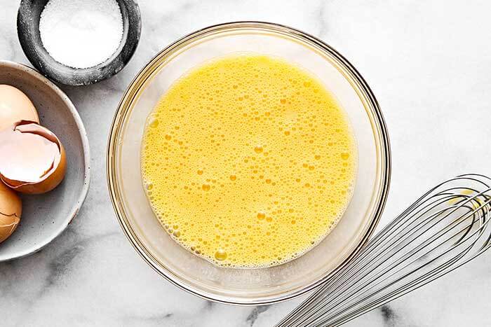 A bowl of whisked eggs.
