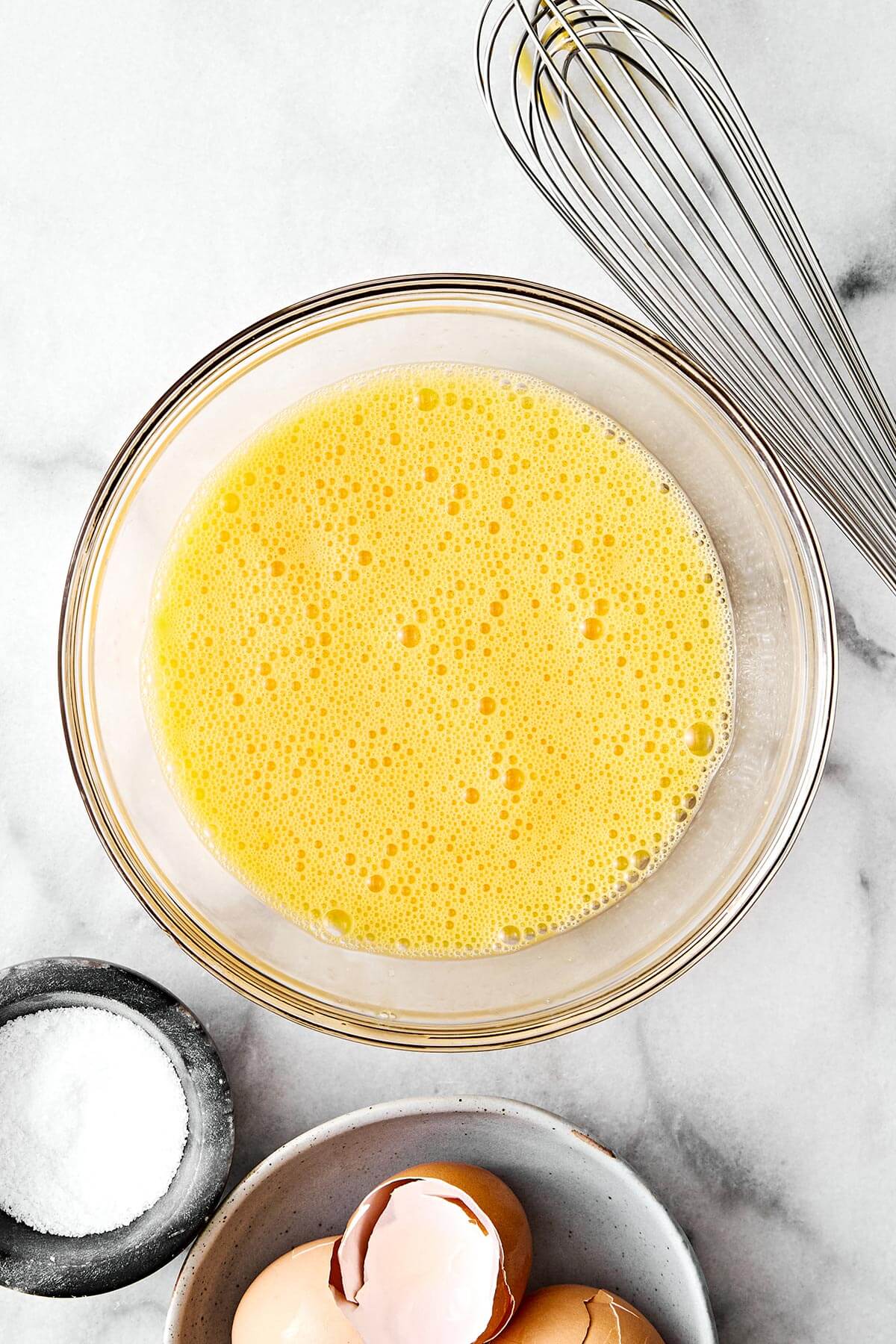 A bowl of whisked eggs.