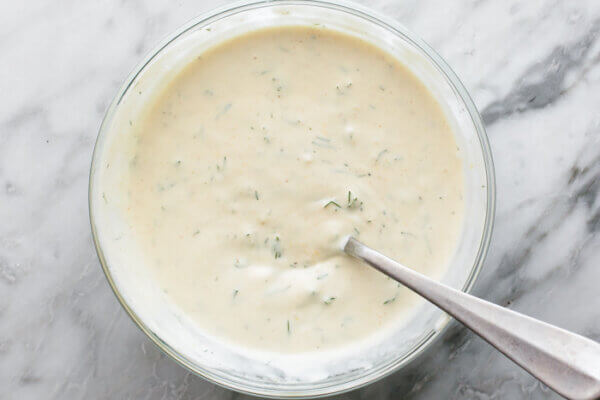 A glass bowl of shrimp salad dressing