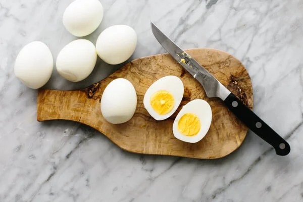 Slicing eggs in half for smoked salmon deviled eggs