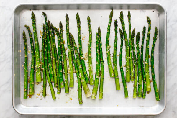 A metal tray of roasted asparagus