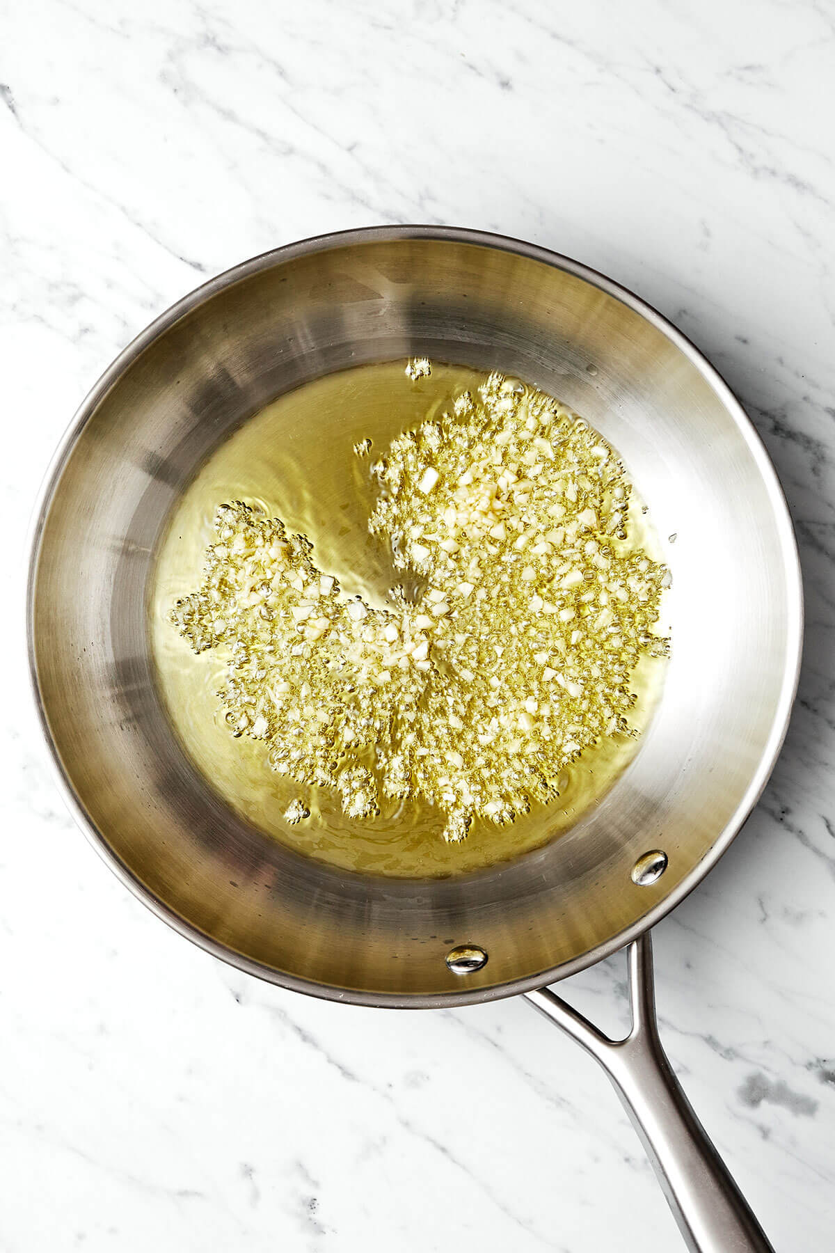 Cooking garlic and oil in a pan.