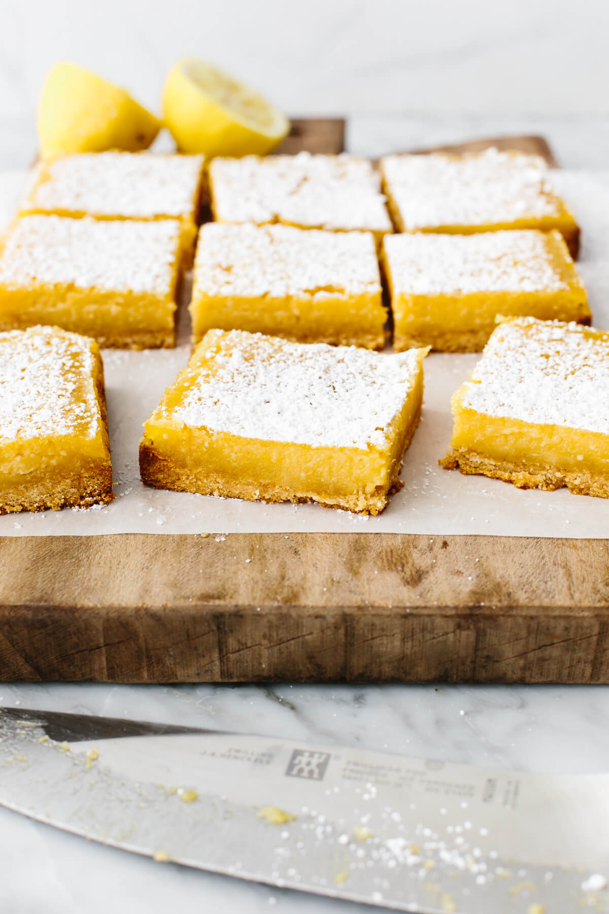 Gluten-free lemon bars on a wooden board.