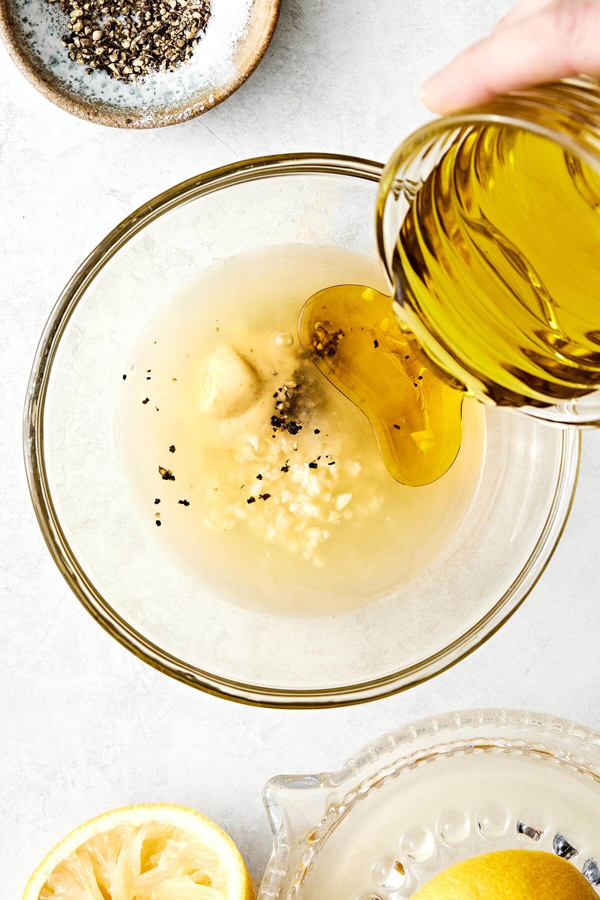 Making a lemon vinaigrette in a bowl.