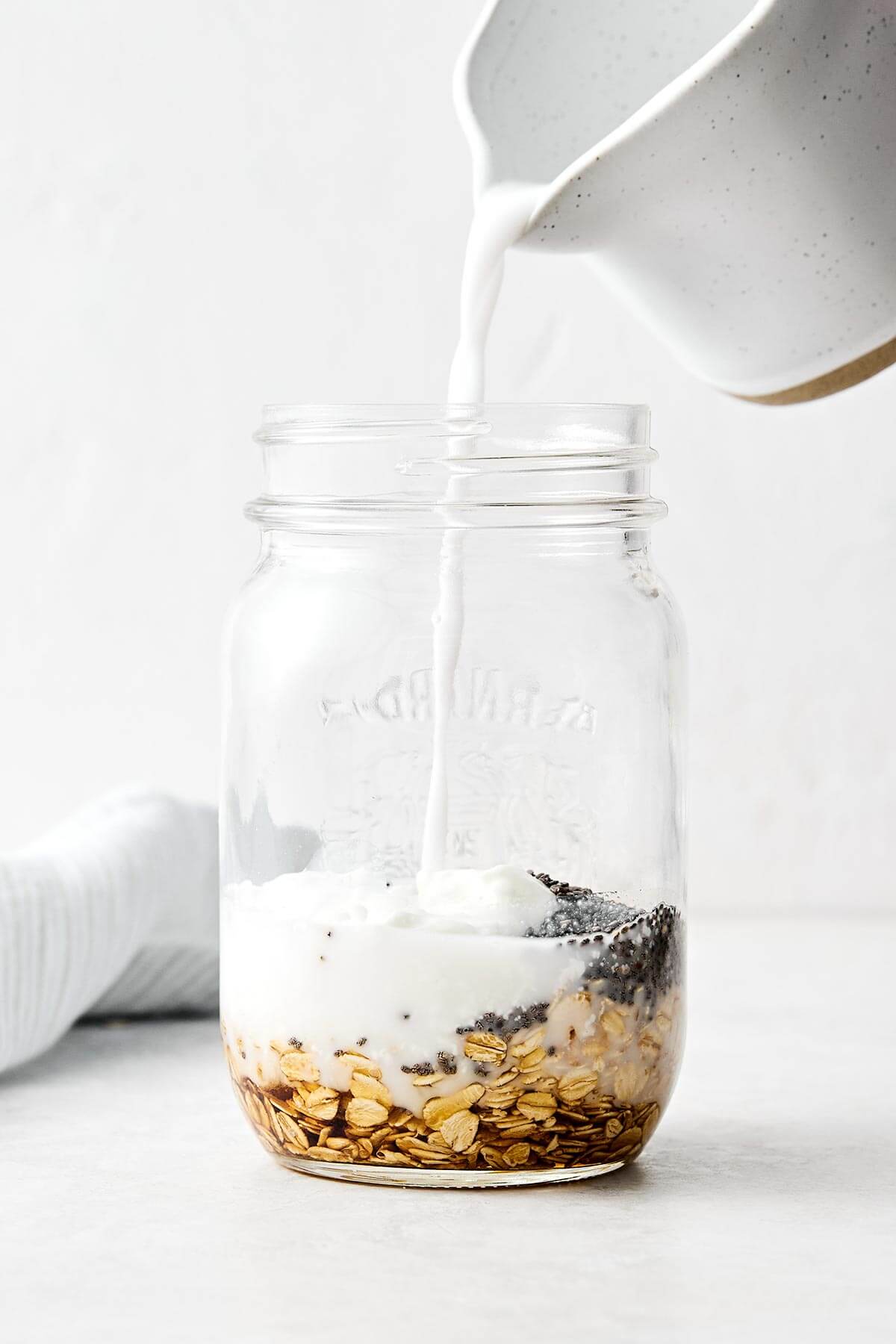 Mixing overnight oats in a jar.