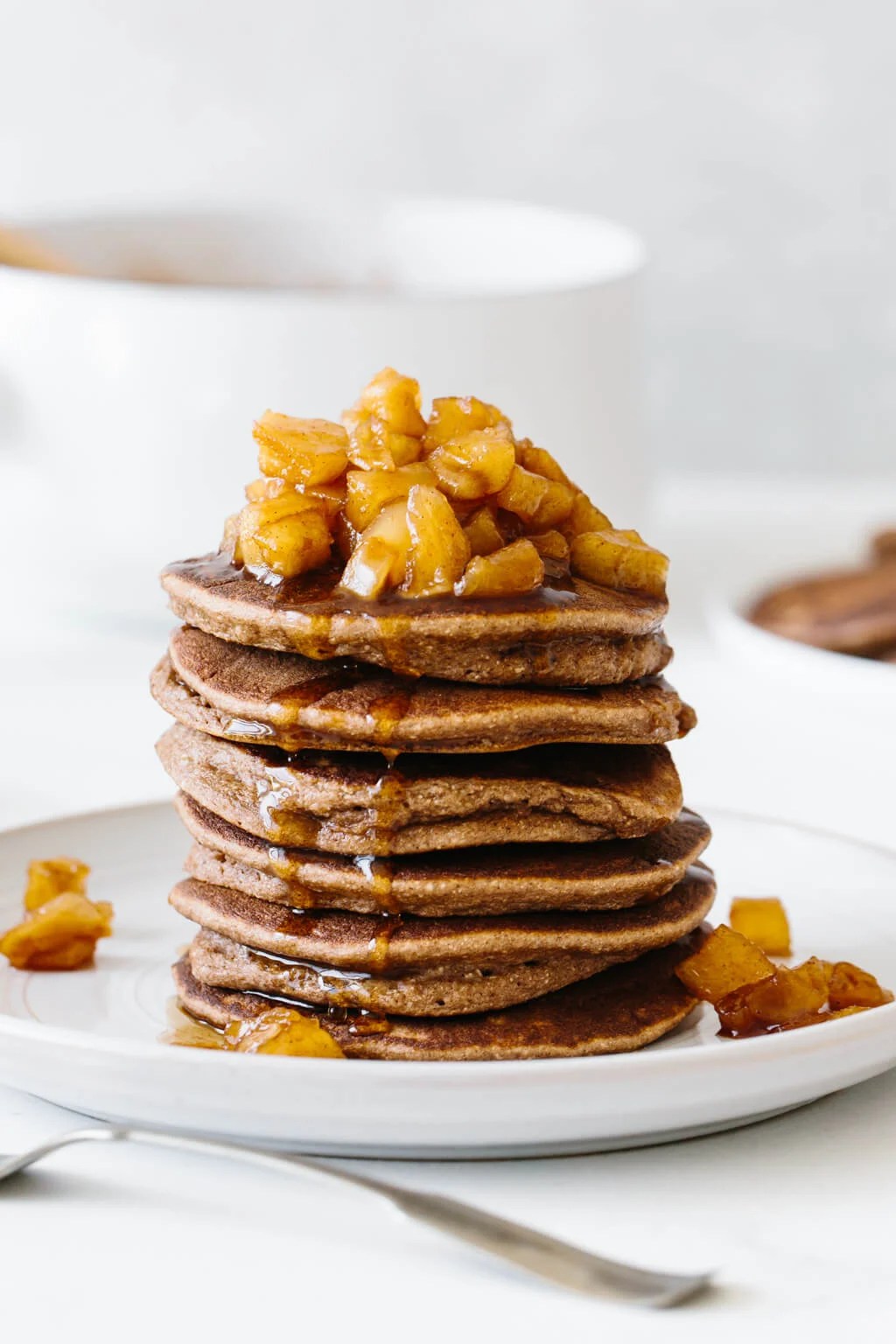 Stack of paleo pancakes with maple apple cinnamon topping.