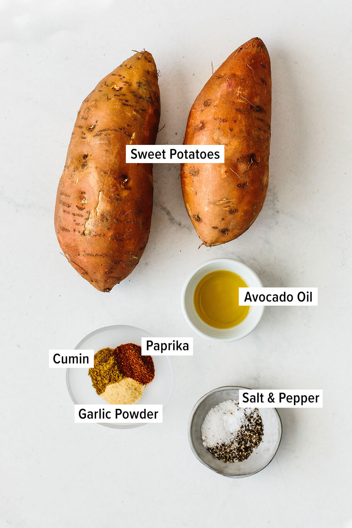 Ingredients for roasted sweet potatoes on a table. 