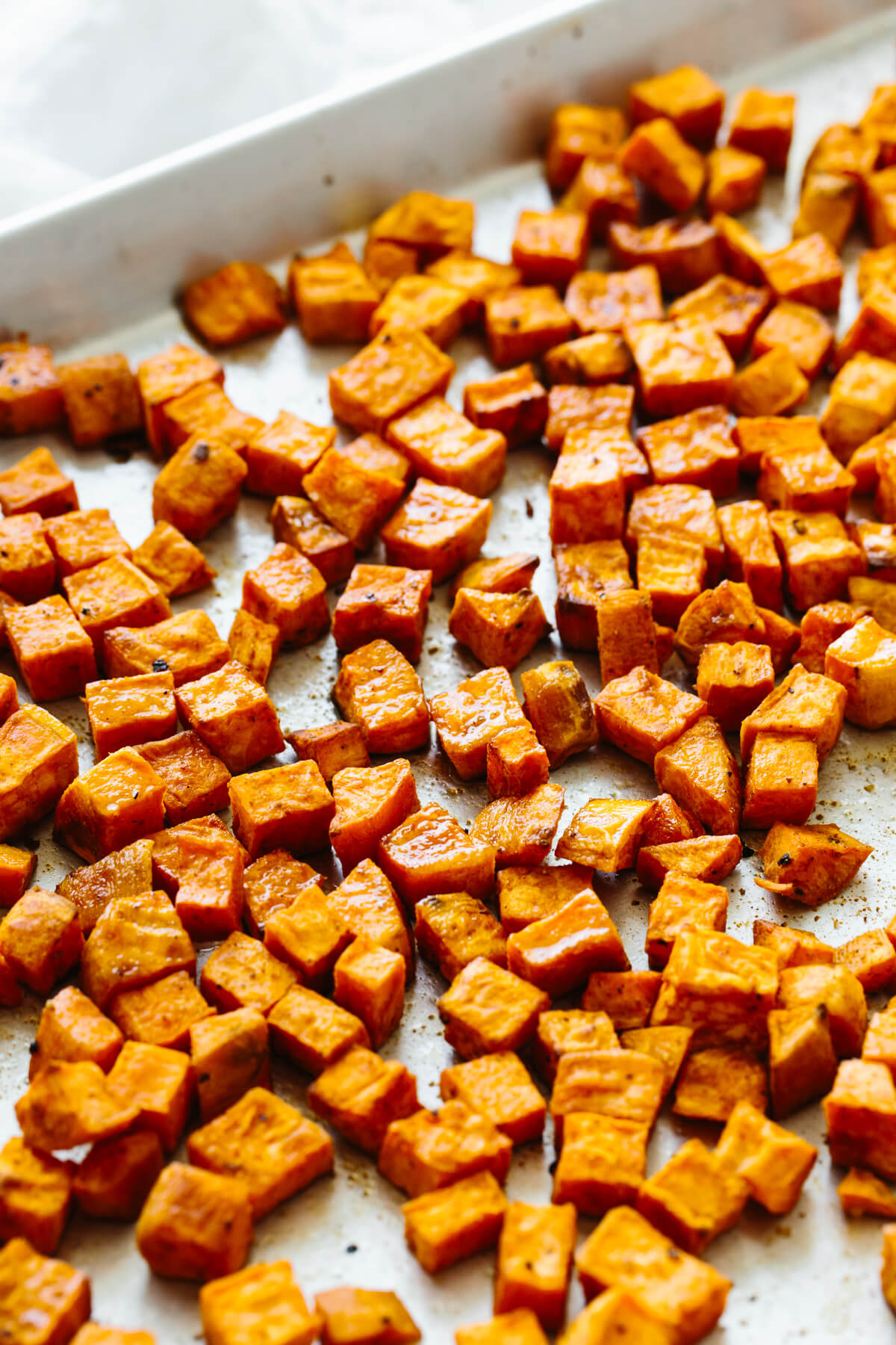 Roasted sweet potato on a sheet pan.