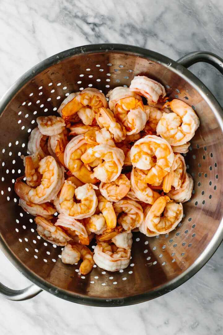Shrimp in a colander before mixing into shrimp salad