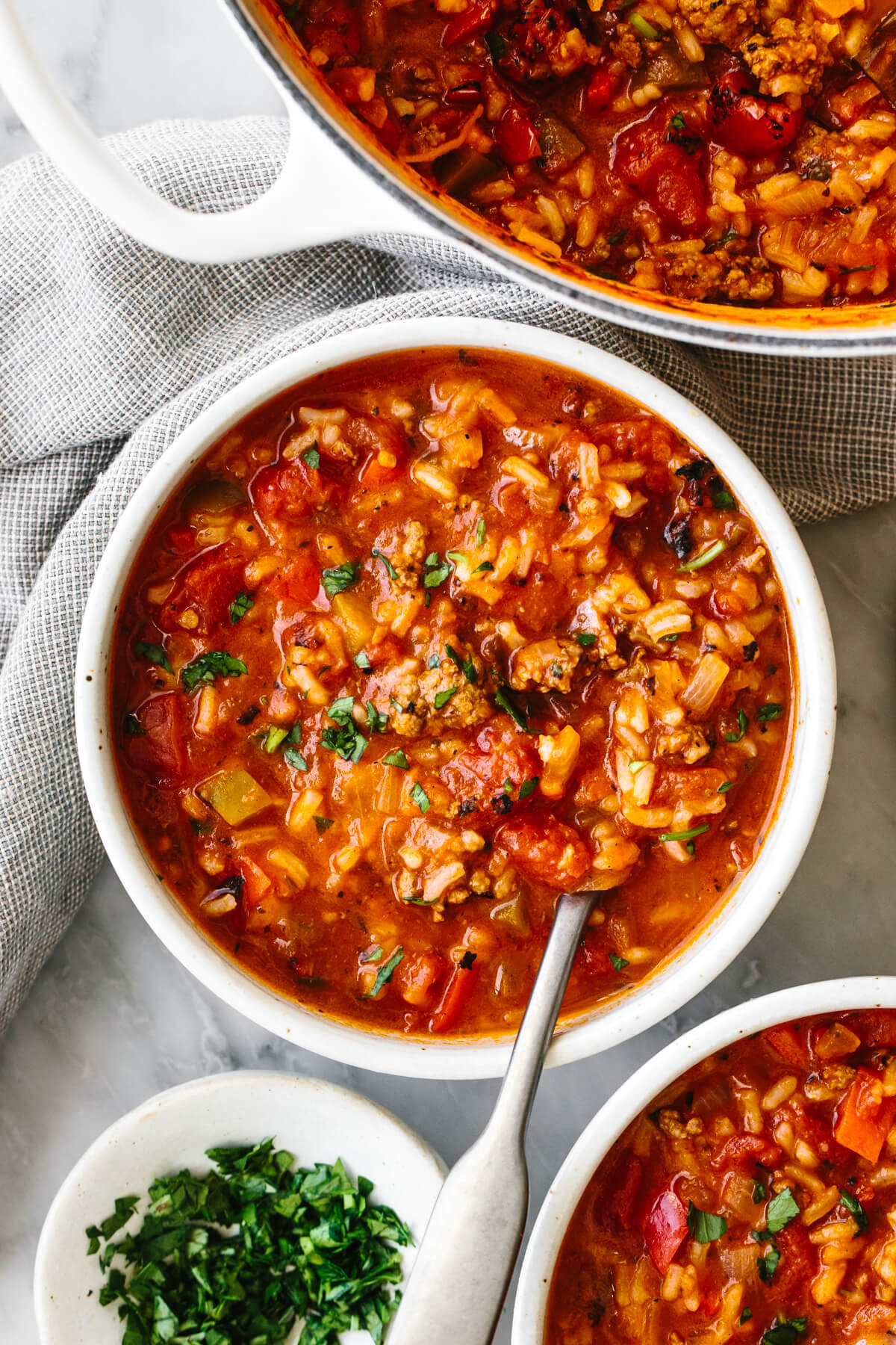 A bowl of stuffed pepper soup next to a napkin