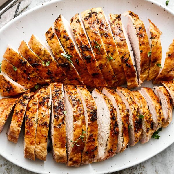 Sliced roasted turkey breast on a platter.