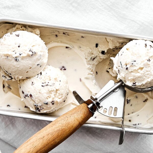Vegan cacao nib ice cream with a scooper.
