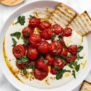 A bowl of whipped feta with roasted tomatoes.